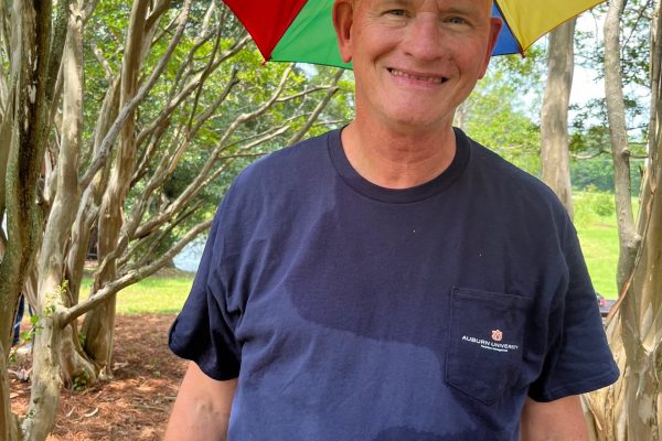 Maintenance’s Bruce Arnold’s umbrella hat is a great idea for a summer picnic. Photo: Sara Newman