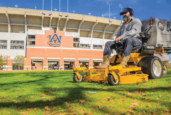 Man mowing Lawn infront of Jordan Hare Stadium
