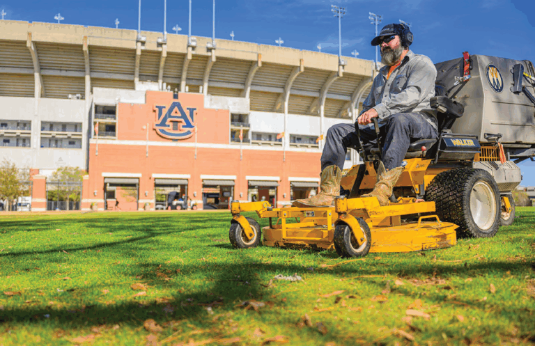 Man mowing Lawn infront of Jordan Hare Stadium