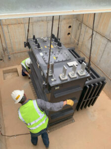 The electrical distribution team installs a transformer at the STEM + Agricultural Sciences Complex.