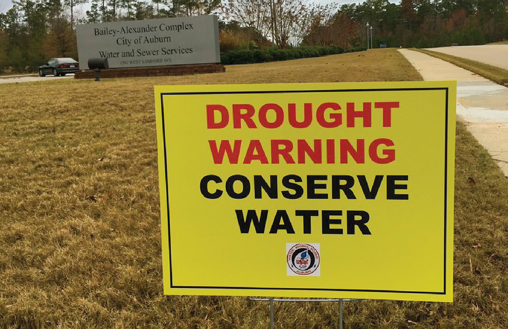 Sign that reads "Drought Warning conserve water"