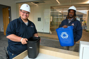 Antonio Lopez and Scott Floyd deliver waste and recycling bins to the new offices.