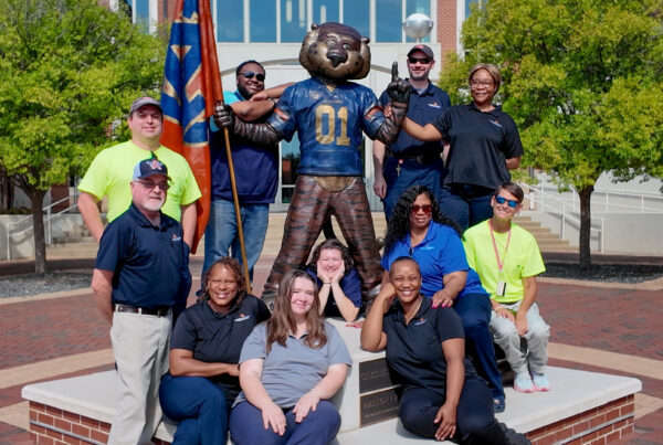 Auburn University Mail Services was recognized as the 2026 Mail Center of the Year by the National Association of College and University Mail Services. Shown front, from left, are Clarence Fox, Tonia Rosser, Jordan Sandlin, Sarah Berry, Jasmine Pressley, Reta Jackson and Denise Kalan, and, back, Bryce Oleson, Manager Anthony Driver, Assistant Manager John Raiford and Rovel Burney.